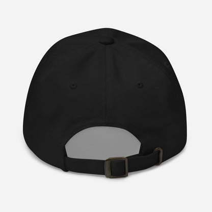 Black cap with antique buckle on back against a white back ground.